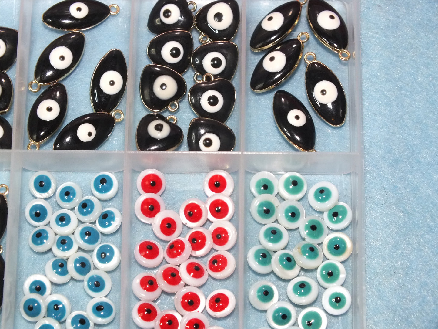 90pcs Evil Eye beads & charms in a storage box, including freshwater shell beads