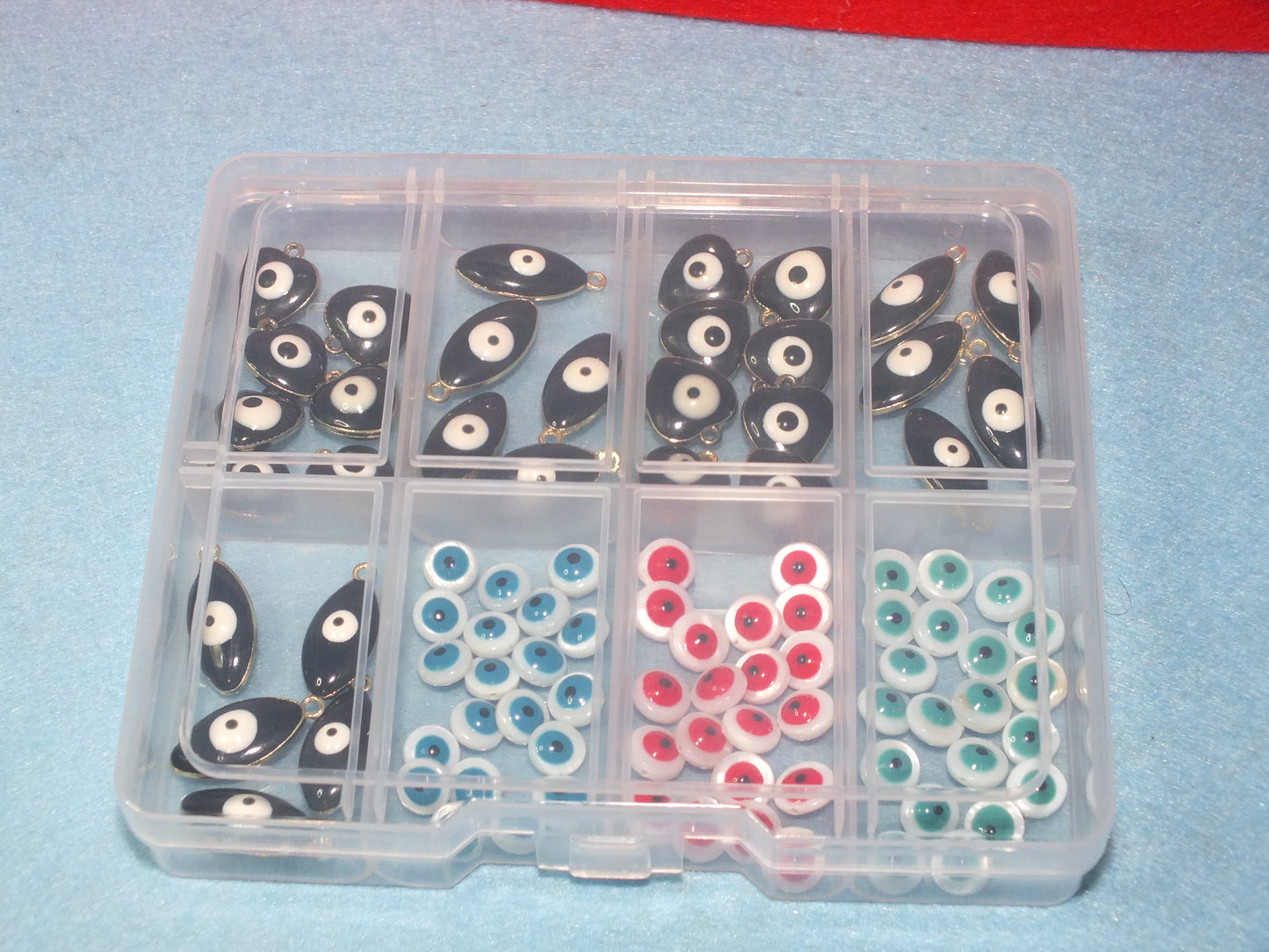 90pcs Evil Eye beads & charms in a storage box, including freshwater shell beads