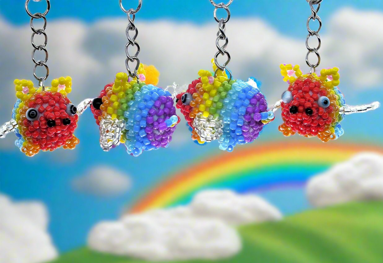 Flying Pride piggies - handmade rainbow beaded pigs (squishy!) on a keyring!