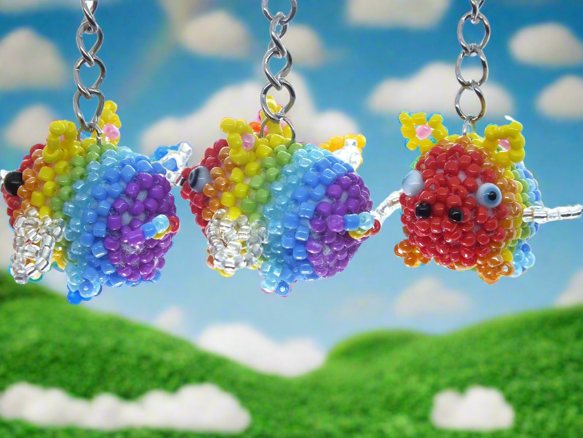 Flying Pride piggies - handmade rainbow beaded pigs (squishy!) on a keyring!