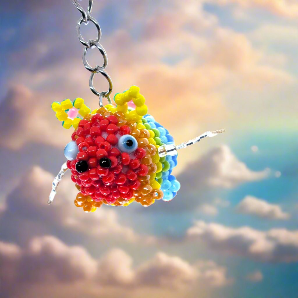 Flying Pride piggies - handmade rainbow beaded pigs (squishy!) on a keyring!