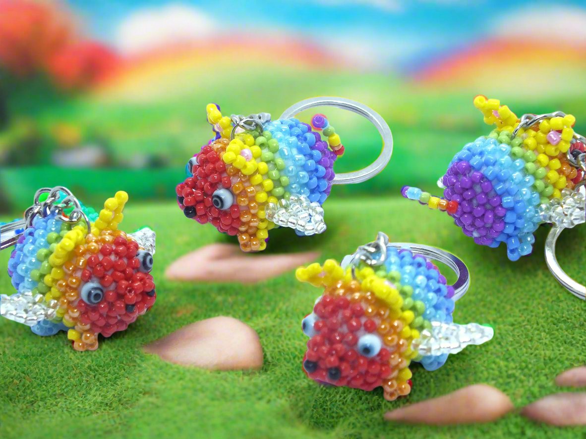 Flying Pride piggies - handmade rainbow beaded pigs (squishy!) on a keyring!