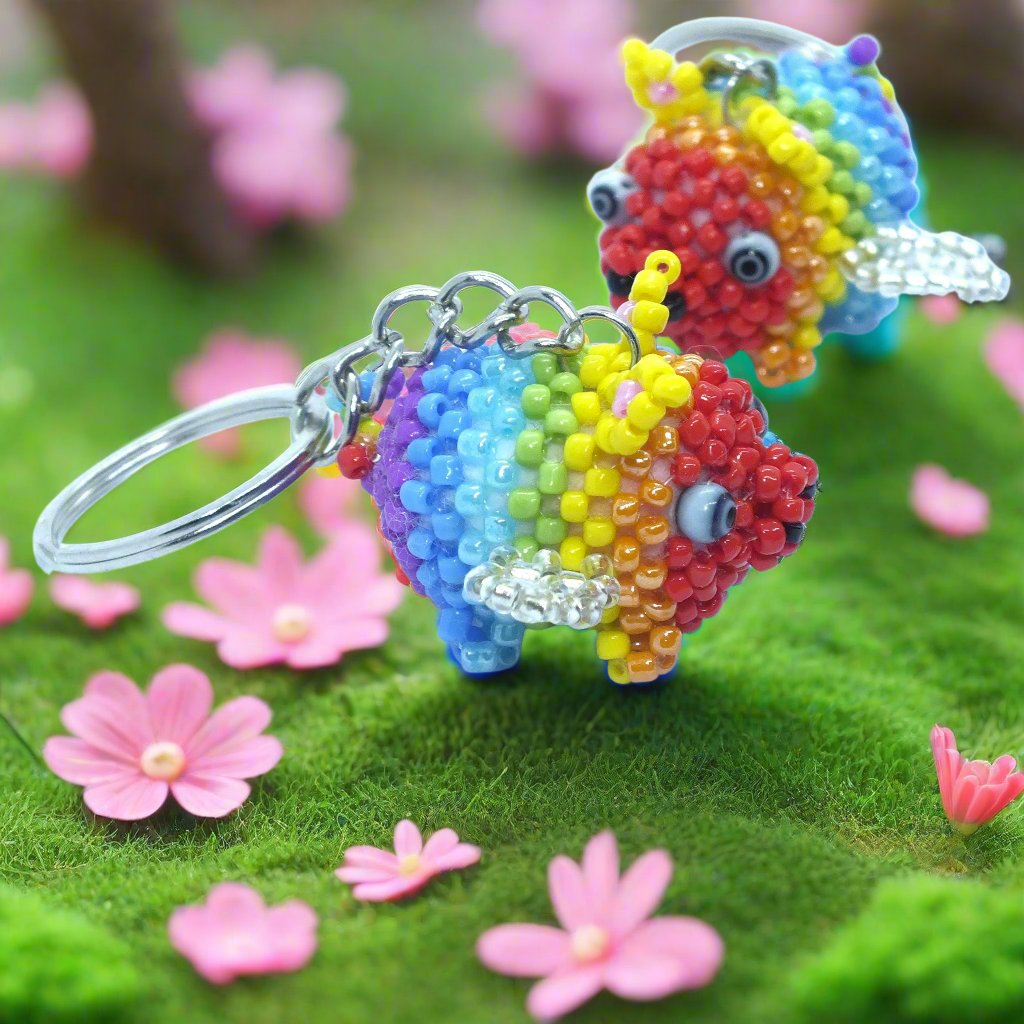 Flying Pride piggies - handmade rainbow beaded pigs (squishy!) on a keyring!