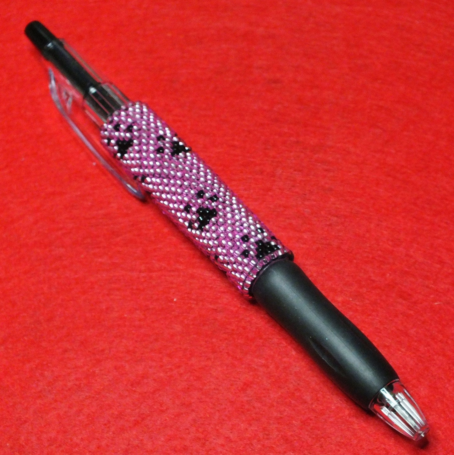 Handmade dog paw beaded pen - pink and black pawprint design.