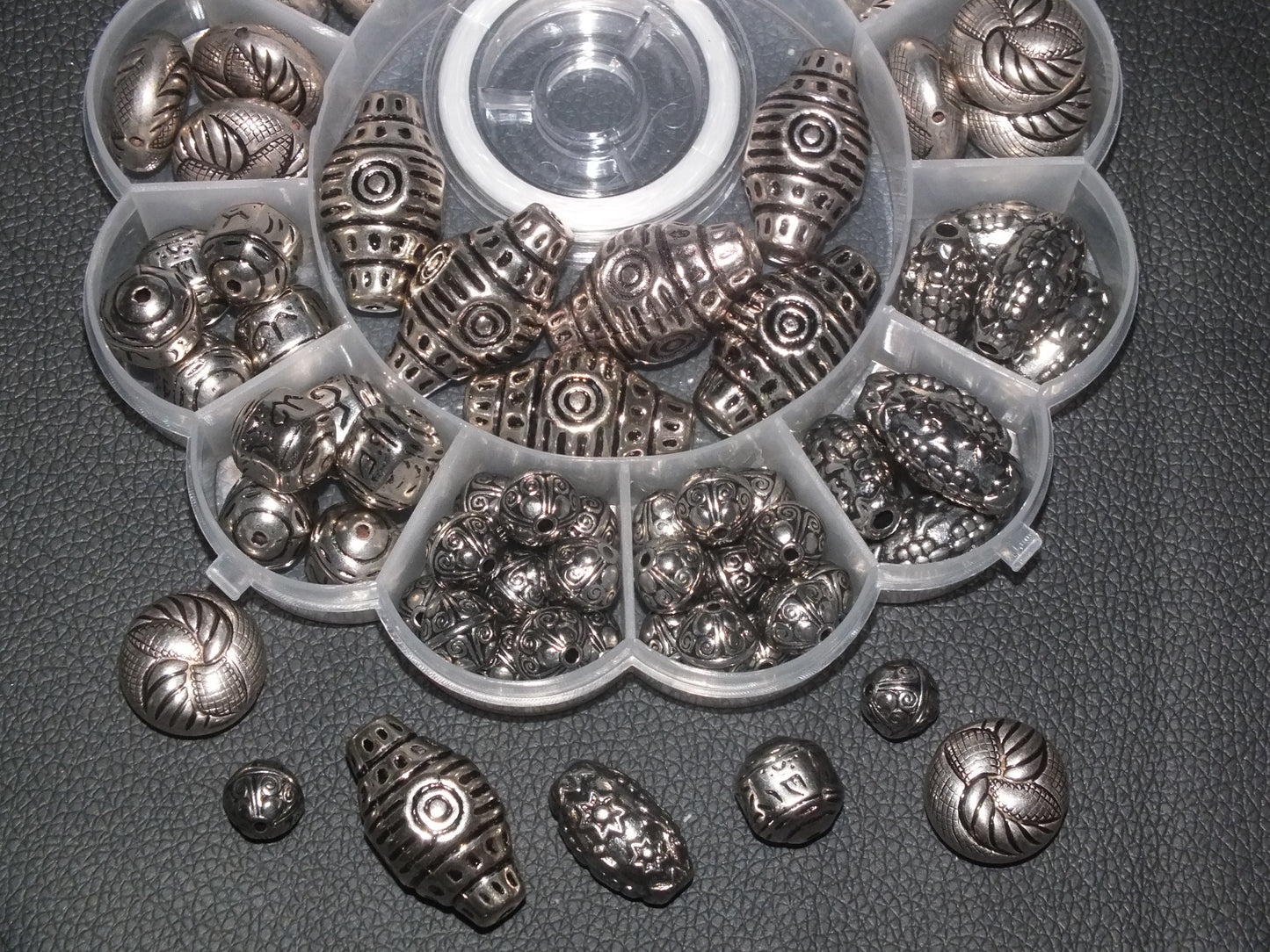 Box of large silver tone beads plus a roll of elastic. 12mm - 33mm mix, 80pcs.