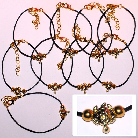 9 handmade gold tone turtle bracelets, on black cord